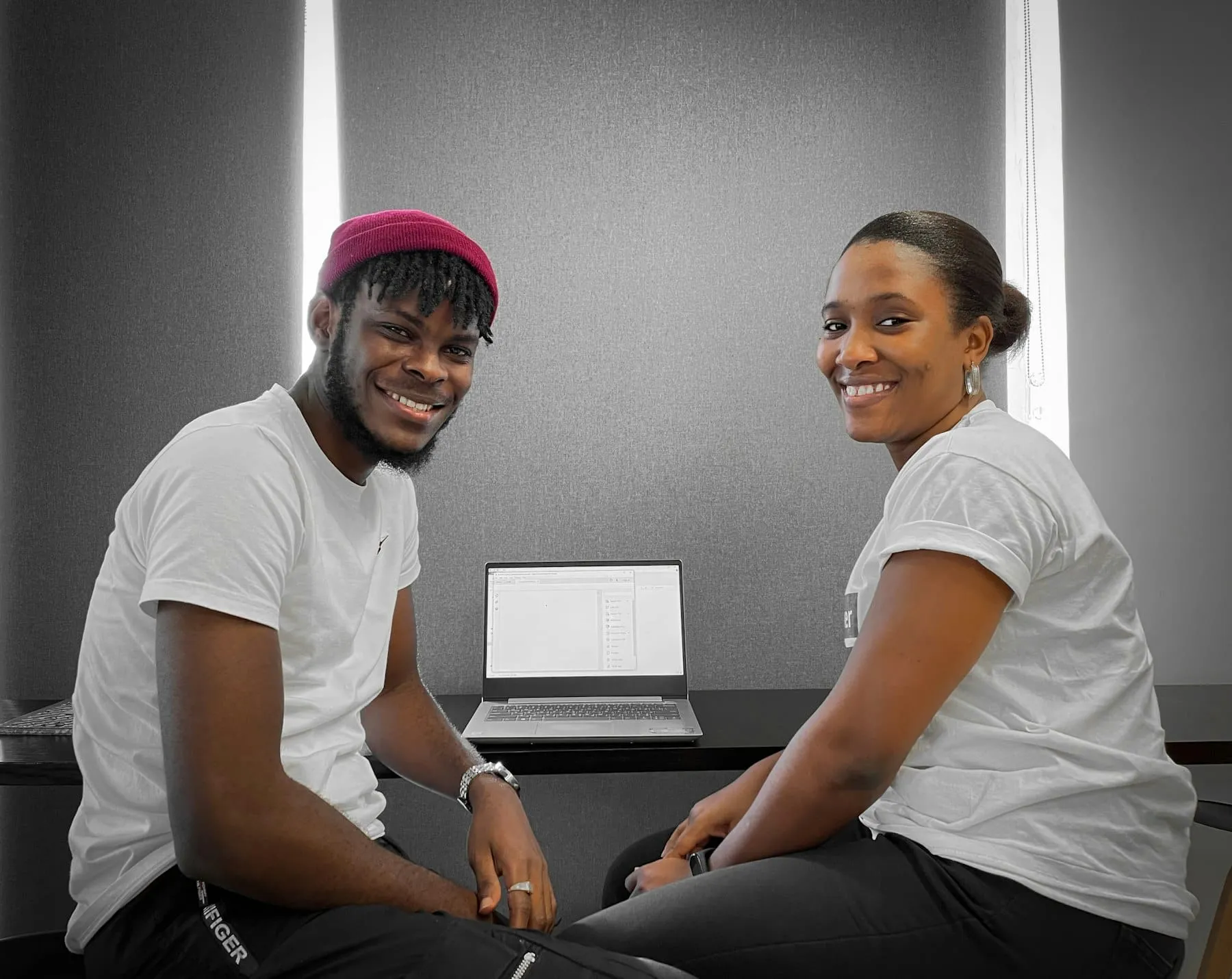 Colleagues smiling at a laptop