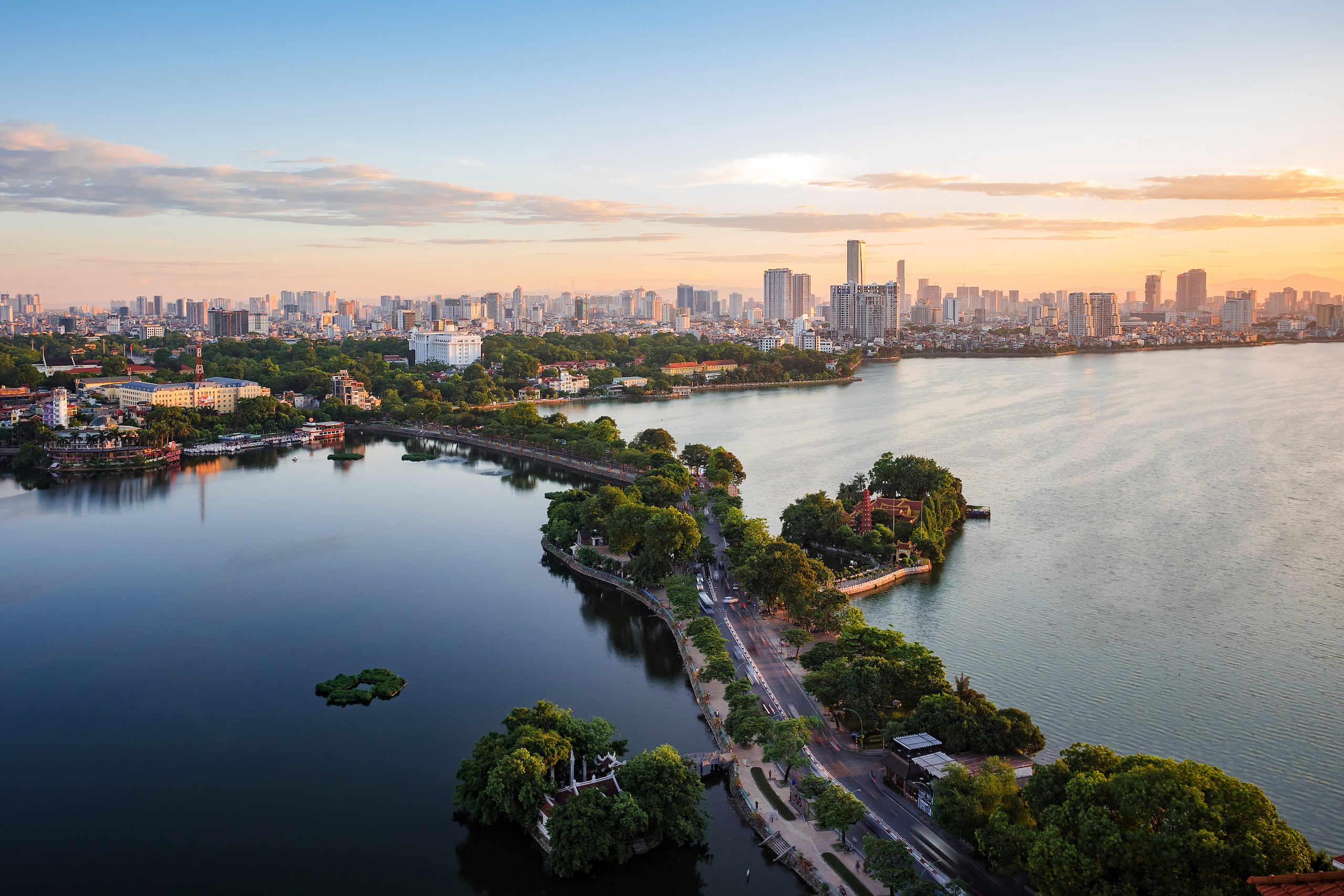 Aerial view of West Lake and the Hanoi skyline at sunset