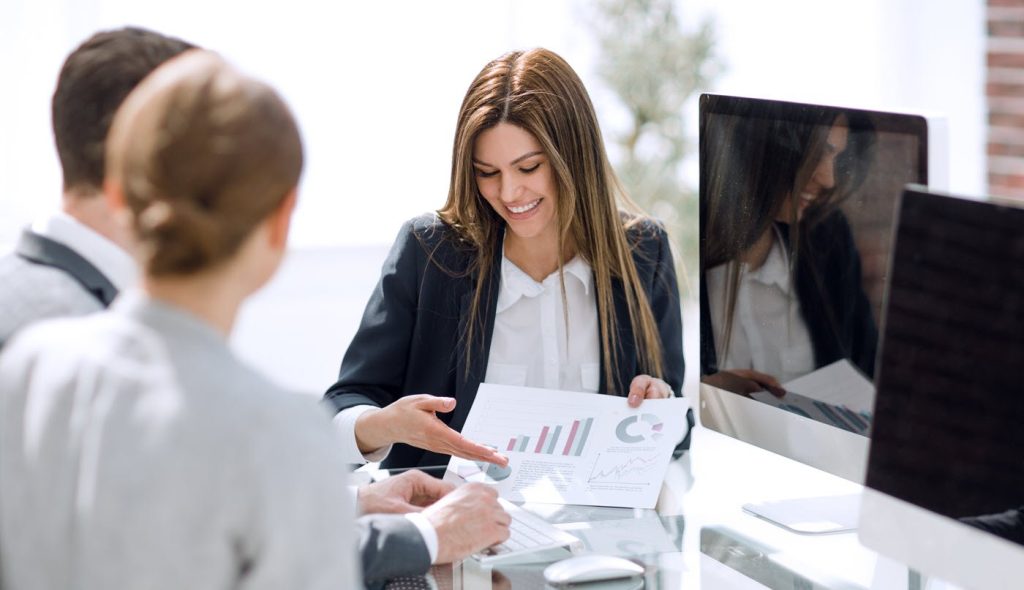 AI for hotel revenue — revenue manager reviewing AI pricing dashboard on laptop