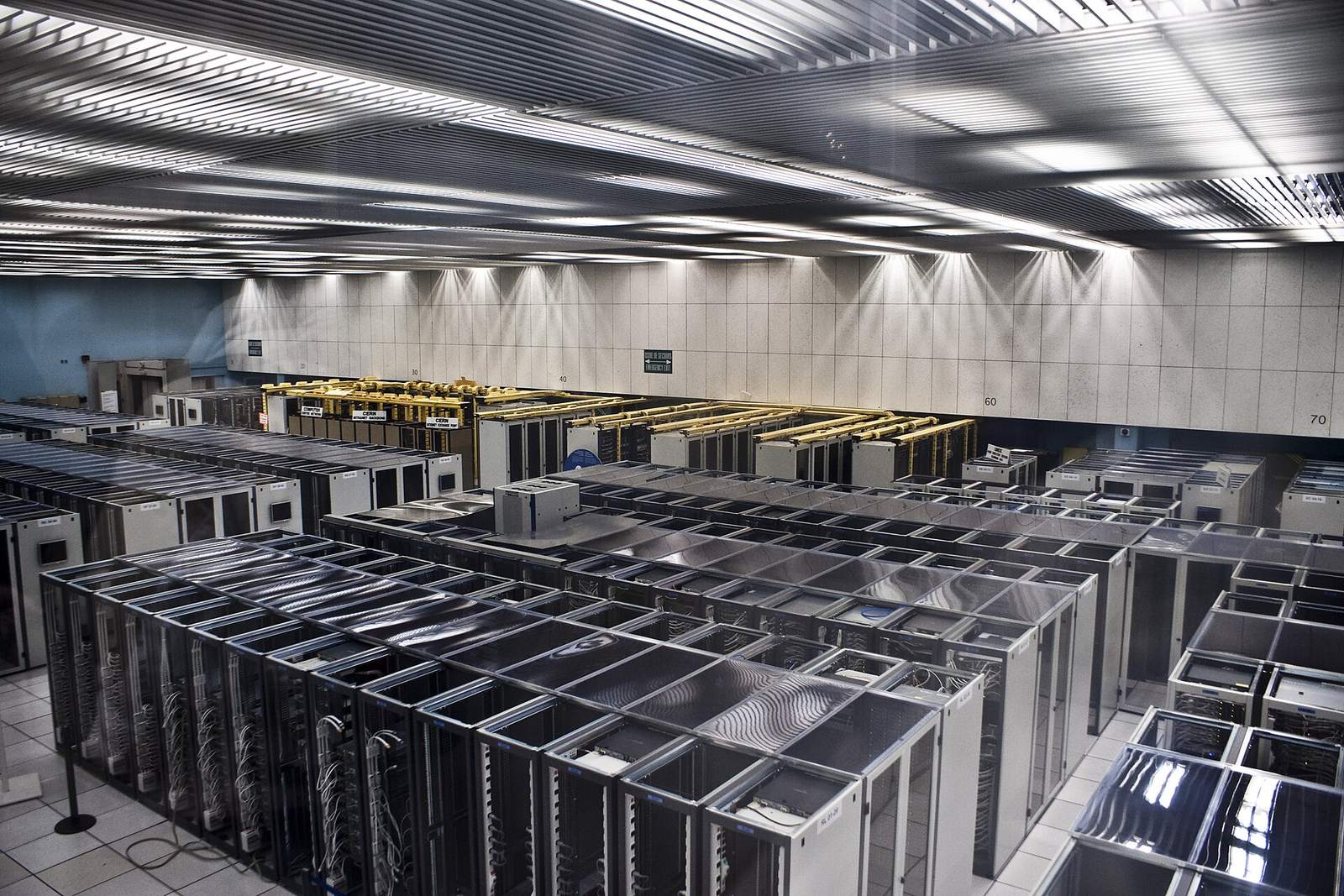 Rows of server racks in a large data centre, representing the many sources AI agents read and cross-check