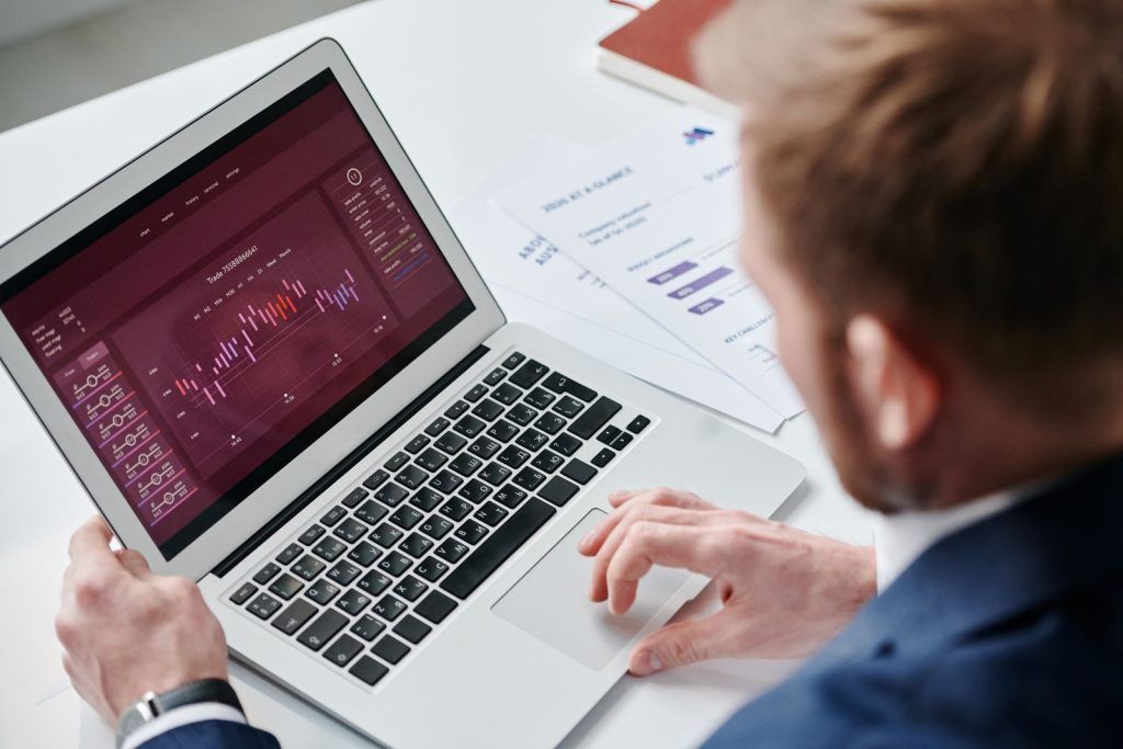 Hotelier reviewing a revenue and analytics dashboard on a laptop, checking AI agent readiness